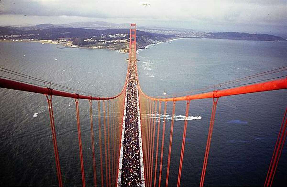 50th Anniversary of the Golden Gate Bridge on May 22, 1987. hundreds of thousands people walked on the traffic lanes of the bridge, as it was closed to traffic all day. View is from the top of the south tower looking north to Ft. Point.