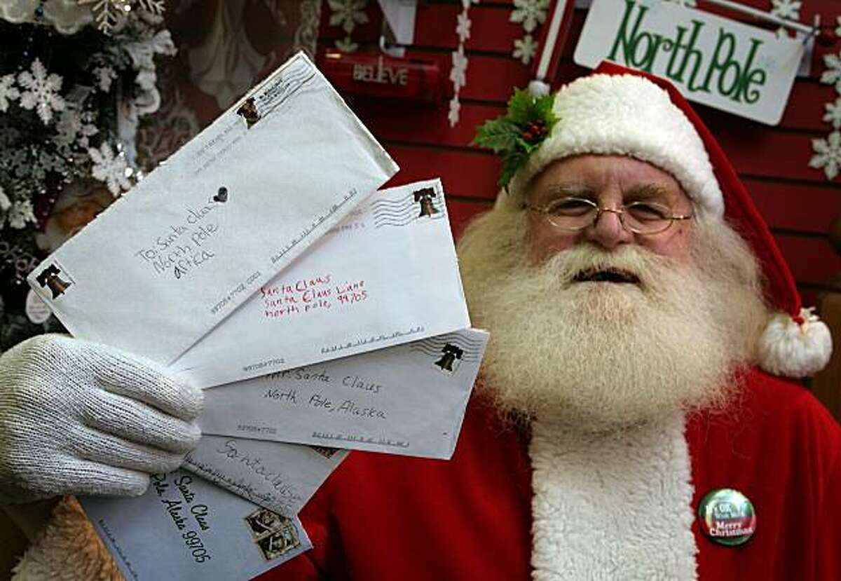 Santa Claus, also known as Patrick Farmer, at Santa Claus House in North Pole, Alaska Wednesday Nov. 18, 2009, holds letters from children sent this year that the U.S. Postal Service says they will no longer deliver. Citing privacy concerns, postal officials say that generically addressed letters to "Santa Claus, North Pole" will no longer be forwarded to volunteers in the Alaska town as has been done for years. (AP Photo/Sam Harrel)