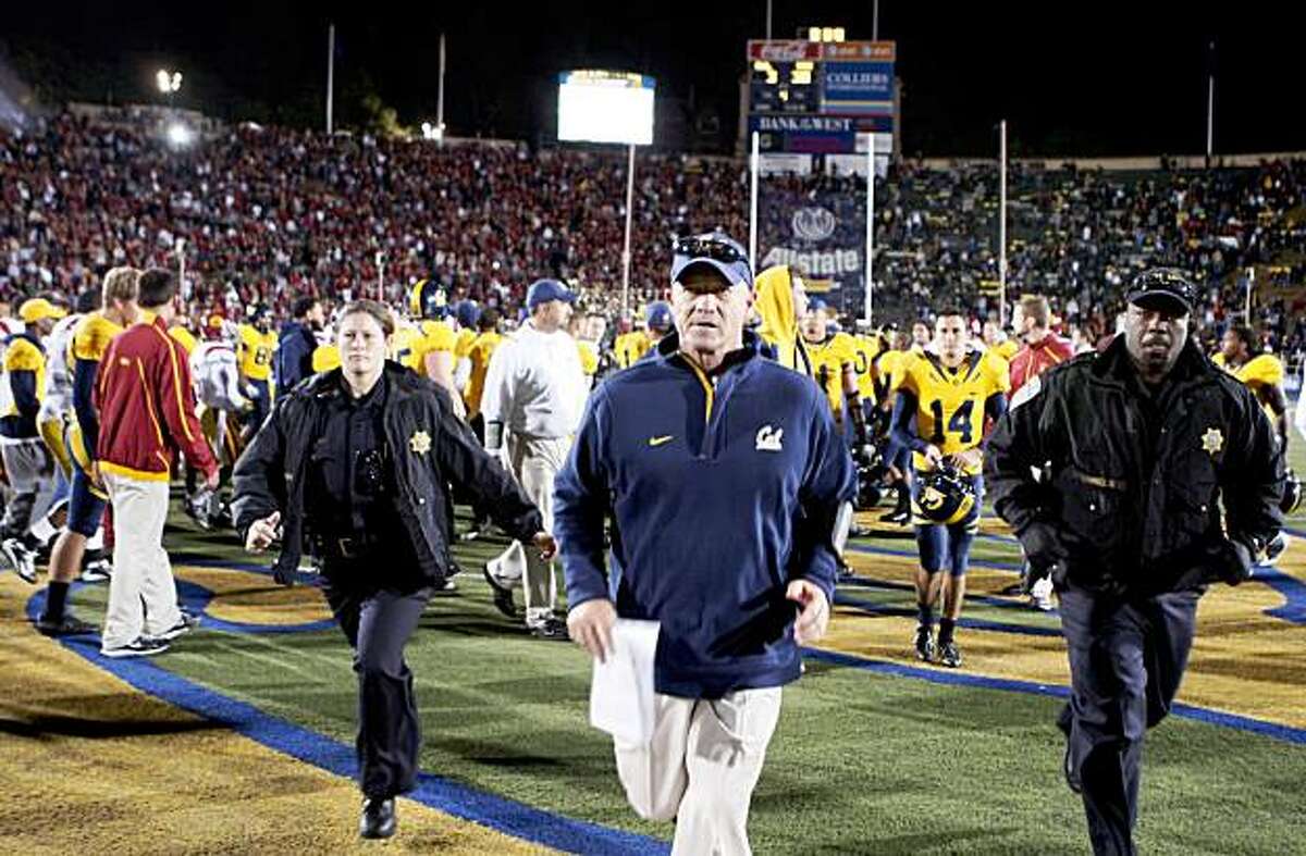 Cal's Head Coach Jeff Tedford runs off Memorial Stadium field in Berkeley after being defeated by USC Saturday Oct 2, 2009 30-3.