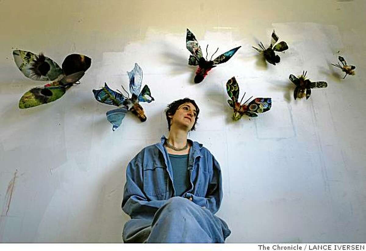 Ana Labastida an artists from Mexico poses for a portrait with her Moths that hang on displays in her new Emeryville studio. Artists from Mexico have been finding a home and some inspiration in the San Francisco Bay area at least as far back as Diego Rivera and Frida Kahlo�s residency here in 1930. Nowadays a crop of young Mexican artists are creating new work here in the Bay Area, bringing a fresh lens to issues like border walls and the fragility of urban landscapes. Photographed in Emeryville Calif, May 1, 2008 Photo By Lance Iversen / San Francisco Chronicle