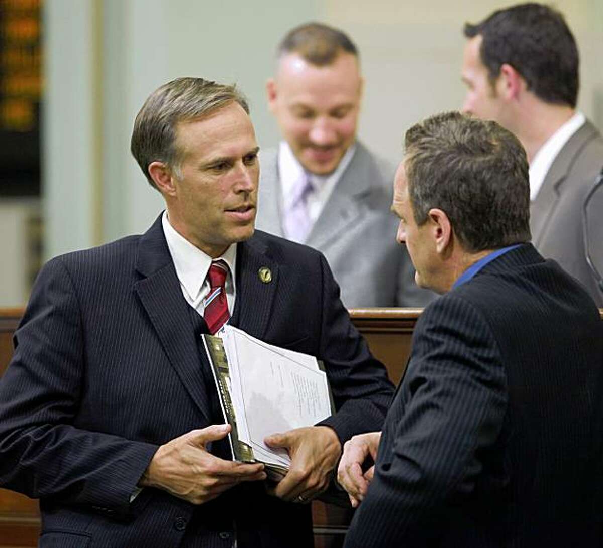 Assemblyman Jared Huffman, D-San Rafael, left, talks with Assembly Minority Leader Sam Blakeslee, R-San Luis Obispo, during the Assembly session at the Capitol in Sacramento on Monday. Huffman is carrying several water measures.