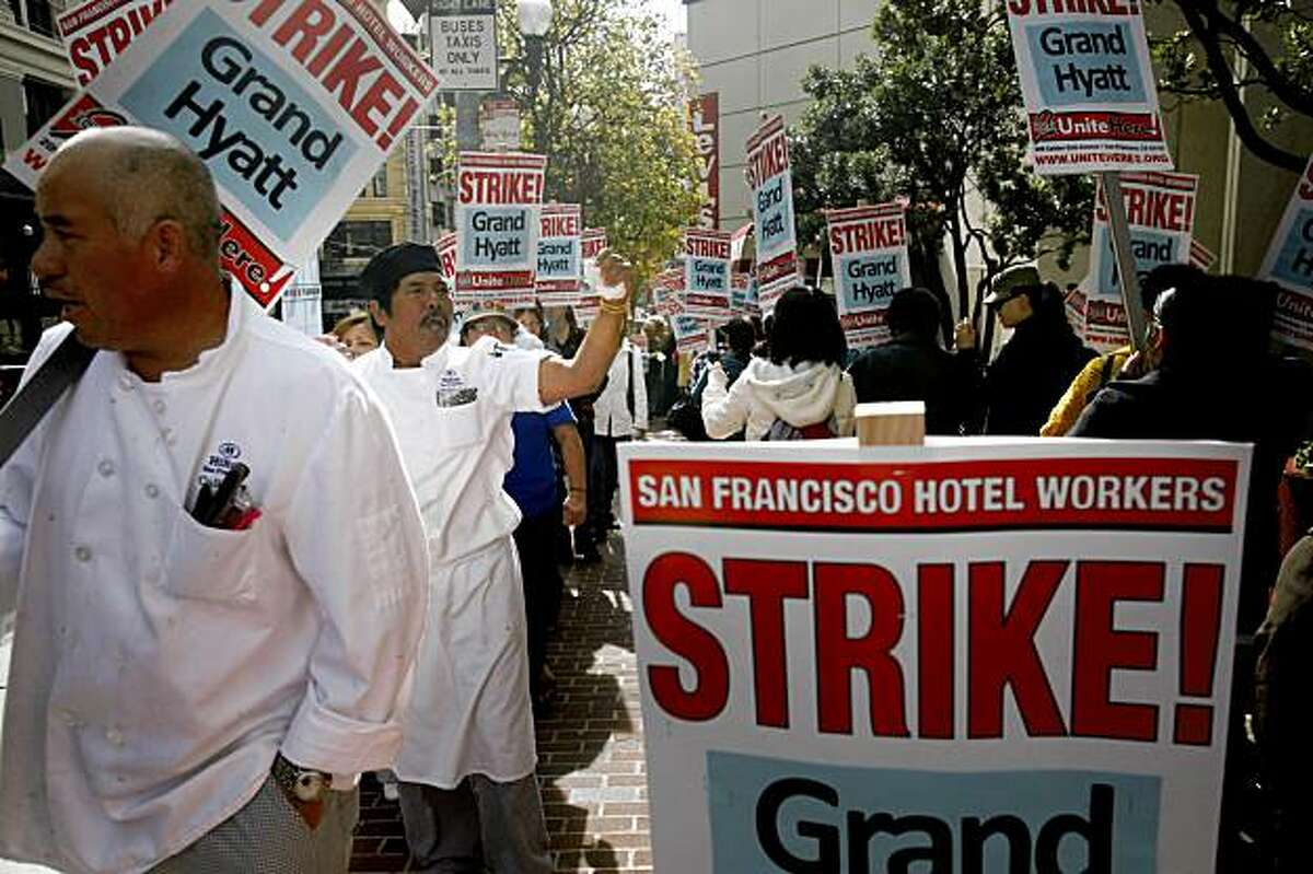 Silveriano Pagtanac, a line cook at a nearby Hilton Hotel, waves his fist in the air as he joins other San Francisco Hotel workers picketing in front of the Grand Hyatt San Francisco on Thursday Nov. 5, 2009 in San Francisco, Calif. after a strike was called earl that morning. "We need to protect our families," said Pagtanac.