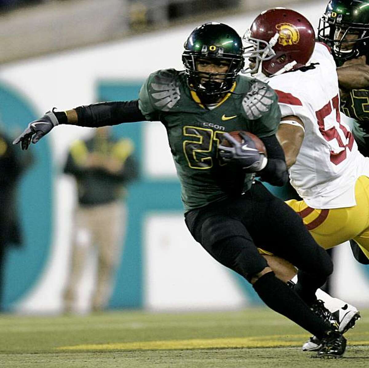 Oregon running back LaMichael James, left, gets past Southern California defender Jarvis Jones (51) during the second half of their NCAA college football game in Eugene, Ore., Saturday, Oct. 31, 2009. James rushed for 185 yards and one touchdown as Oregon beat USC 47-20. (AP Photo/Don Ryan)