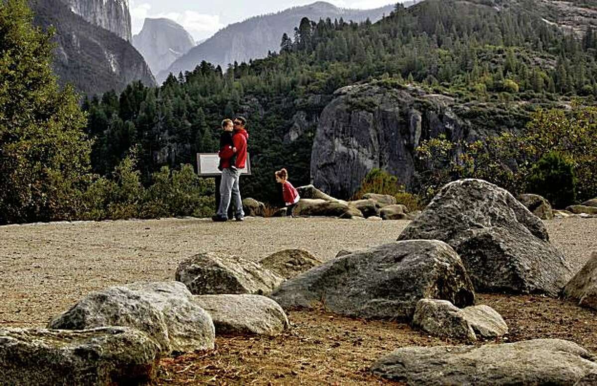Dusty Bruce of New Mexico holds his son Tyler as his daughter Aspen looks around the newly renovated Half Dome overlook along Highway 120 on the Western entrance to Yosemite National Park on Thursday October, 2009. A grove of rocks are placed just so at the edge of the parking lot along the walkway at the Half Dome View, as an effort is underway to improve the design of infrastructure of the park in a way to fit into the character of Yosemite.