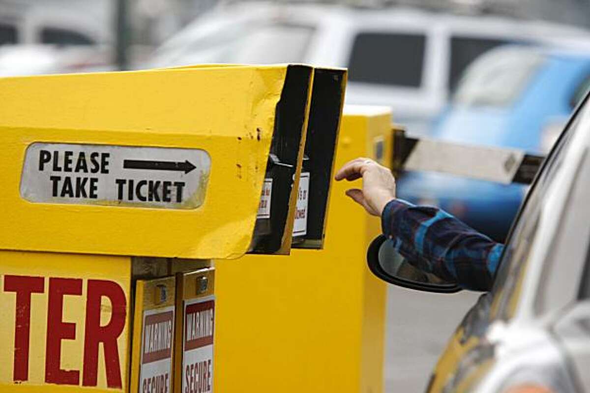 A visitor pulls a fare ticket at Fisherman's Wharf parking lot.