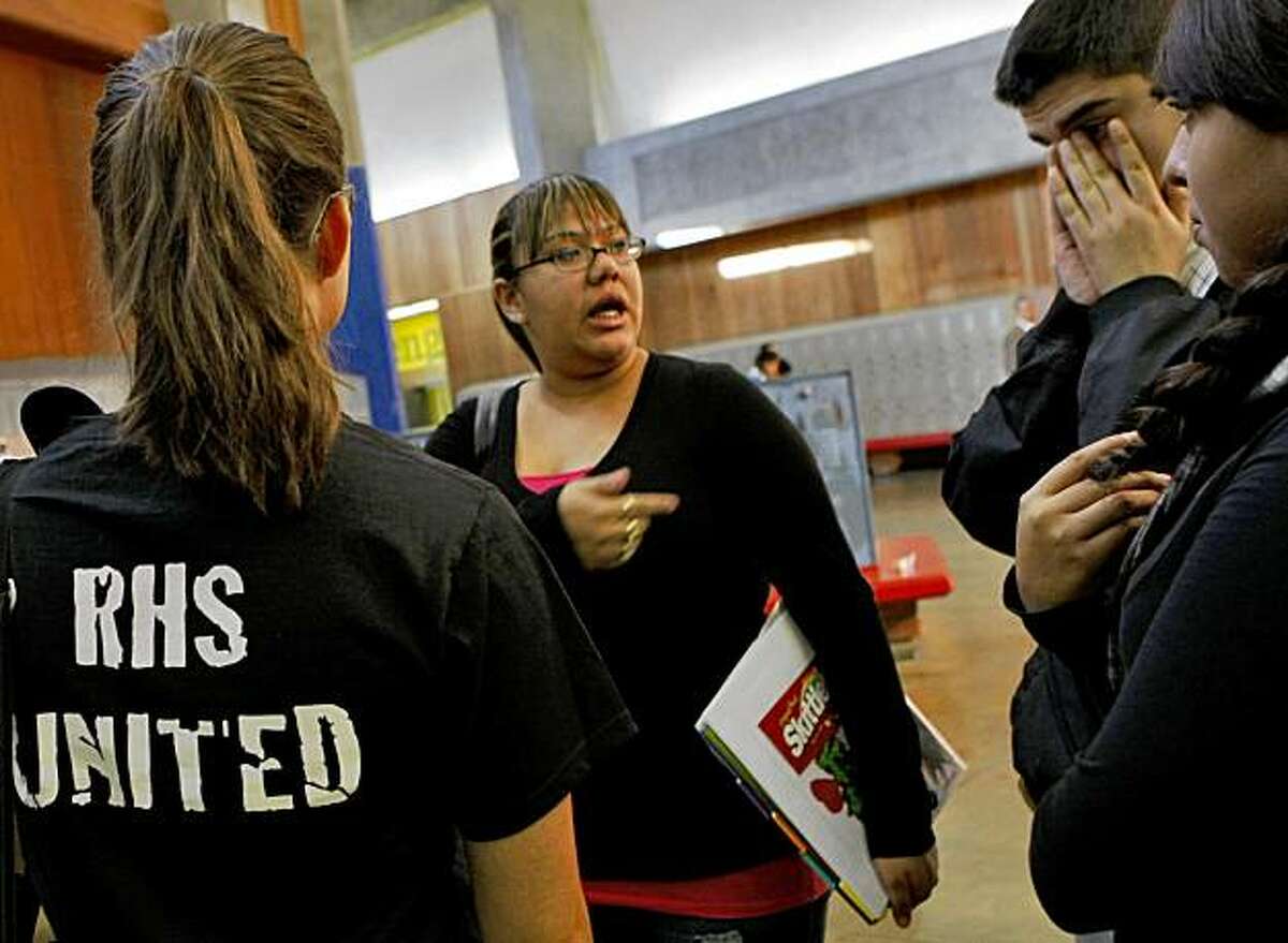 Teacher Jessica Price, left, talks with Carina Contreras and other students who were angry about negative comments that were being made about the victim of the gang rap, Thursday Oct. 29, 2009, in Richmond, Calif.