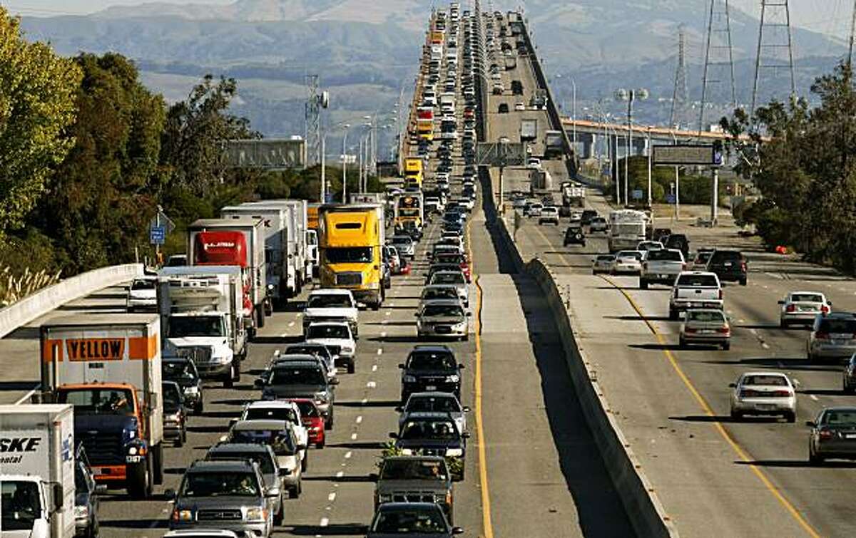 West bound highway 92, (left) slows as commuters, at mid-morning, cross over the high rise section of the San Mateo Bridge into Foster City, Calif, on Wednesday October 28, 2009, after an earlier repair to the Bay Bridge, failed Tuesday night shutting down the span into San Francisco.
