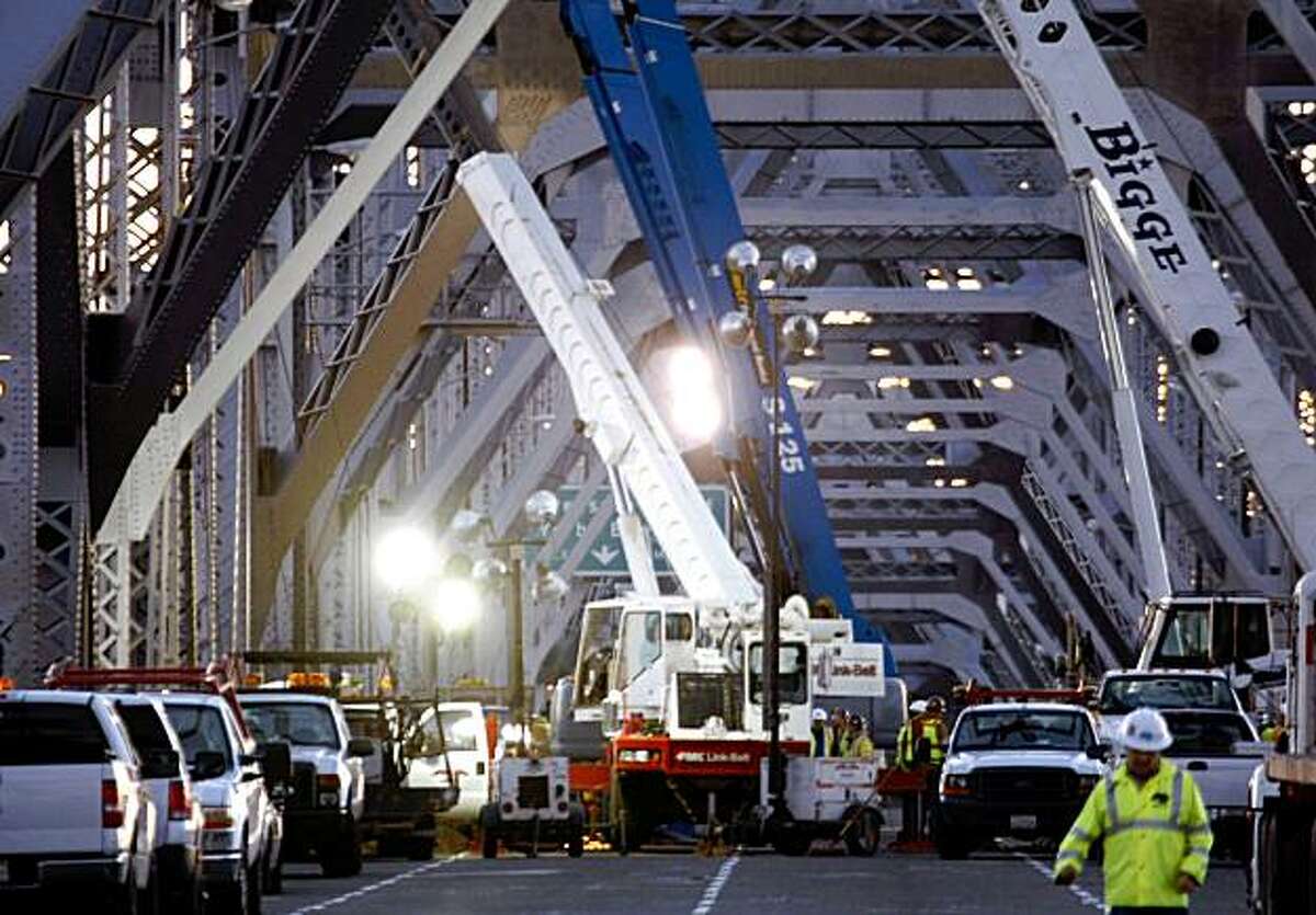 Crews work on the saddle and tie-rods that failed on the Bay Bridge.