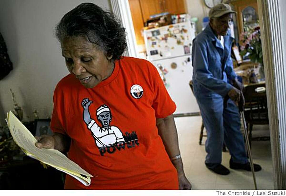 Esselene Stancil, left, who has lived in her home since 1965, looks over Proposition F flyers in San Francisco, Calif., on Wednesday, May 21 2008. Her husband Ben Stancil is in the background on the right.