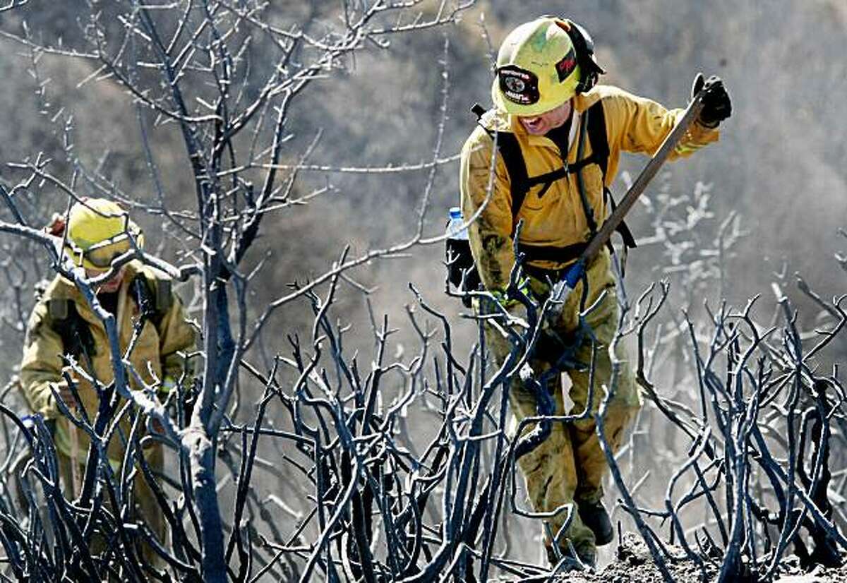 Cal Fire crews worked on hot spots along the Loma fire area. The Loma fire high above Santa Cruz didn't grow much Monday October 26, 2009 and residents were allowed back in although questions remained about Cal Fire's role in the start of the fire.
