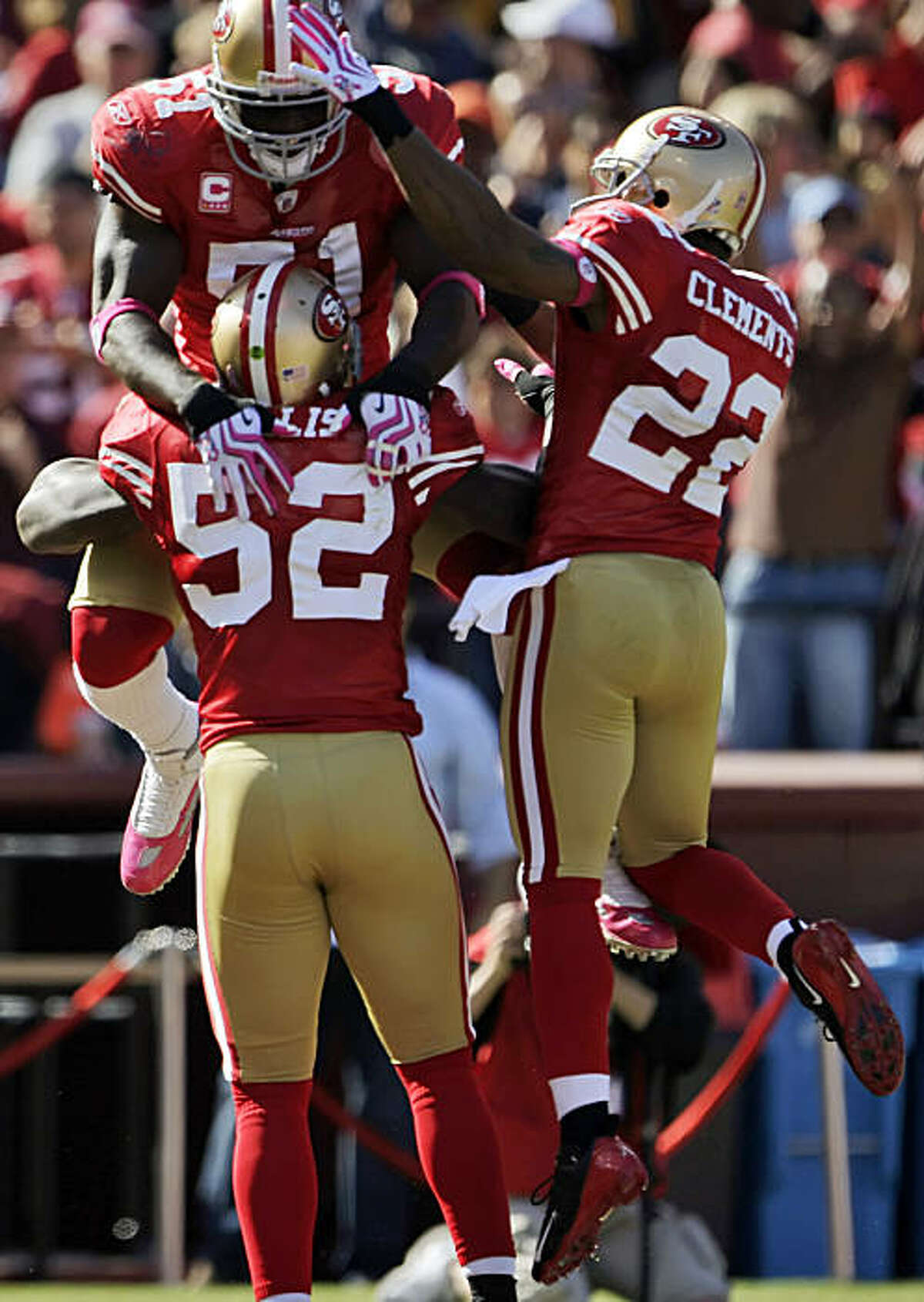 49ers Takeo Spikes, top, and Nate Clements, right, celebrate with Patrick Willis after Willis intercepted a Kyle Boller pass and ran it back for a touchdown in the third quarter of their game against the St. Louis Rams at Candlestick Park in San Francisco on Sunday.