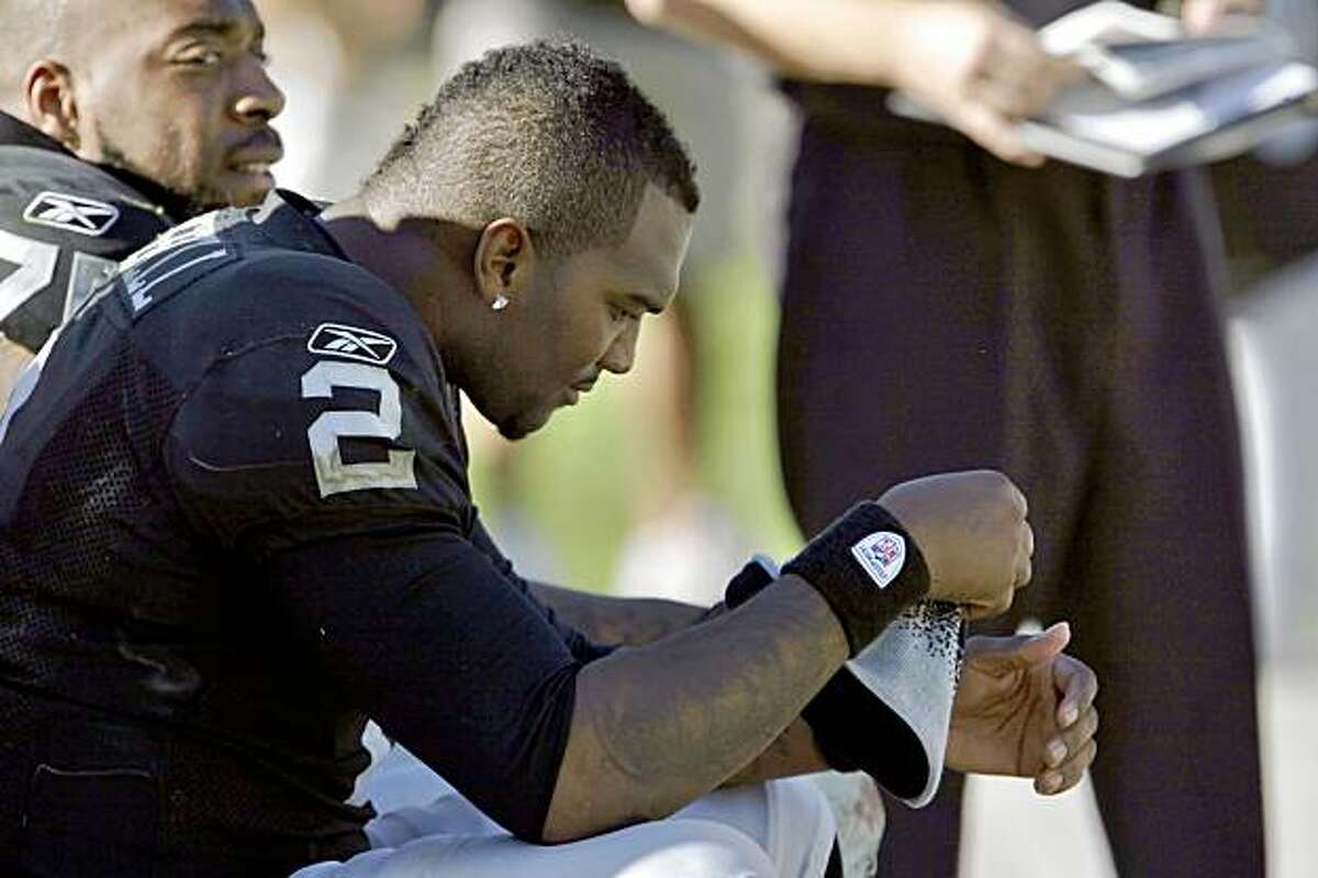 JaMarcus Russell sits on the bench after being taken out of the game in the second quarter.