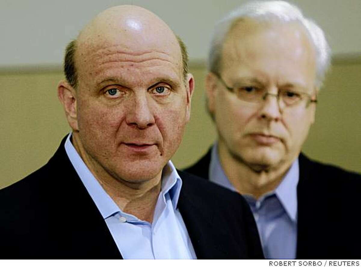 Microsoft CEO Steve Ballmer (L) with Ray Ozzie, chief software architect at his side, speaks to reporters at a news conference at the company headquarters in Redmond, Washington, February 21, 2008. Ballmer announced that Microsoft was changing its technology and business practices to increase openness of its products and bring greater interoperability and choice for developers, partners, customers and competitors. REUTERS/Robert Sorbo (UNITED STATES)