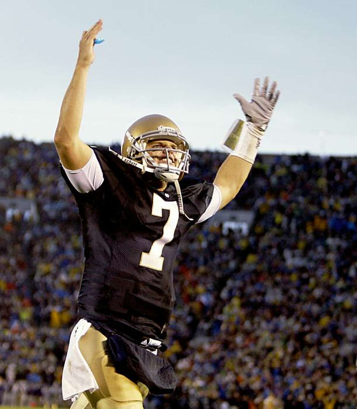 Notre Dame quarterback Jimmy Clausen celebrates a two-point conversion to take a three point lead over Washington late in the fourth quarter during an NCAA college football game in South Bend, Ind., Saturday, Oct. 3, 2009. Notre Dame defeated Washington 37-30 in overtime. (AP Photo/Michael Conroy)