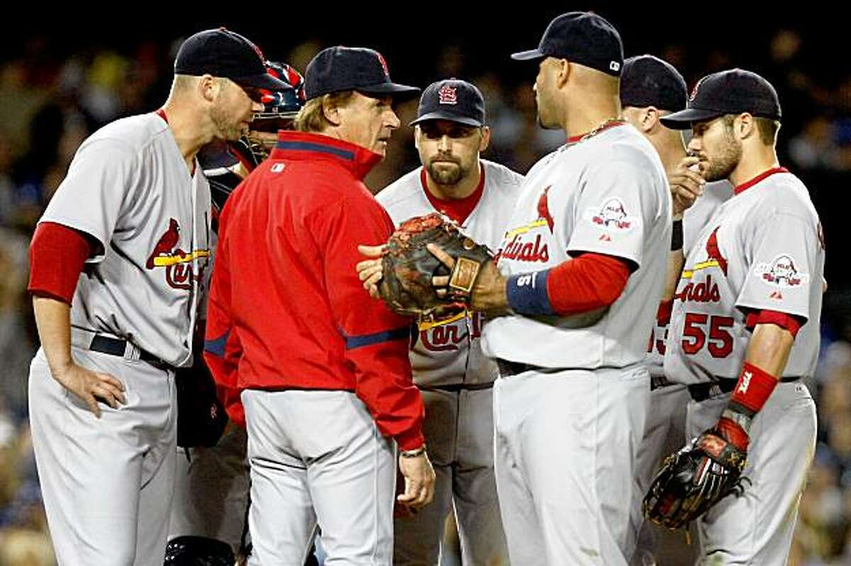 LOS ANGELES, CA - OCTOBER 07: (2nd L) Manager Tony La Russa of the St. Louis Cardinals has a meeting at the mound with (L) pitcher Chris Carpeneter #29 and (2nd R) Albert Pujols #5 in the fifth inning against the Los Angeles Dodgers of the St. Louis Cardinals in Game One of the NLDS during the 2009 MLB Playoffs at Dodger Stadium on October 7, 2009 in Los Angeles, California. (Photo by Jeff Gross/Getty Images)