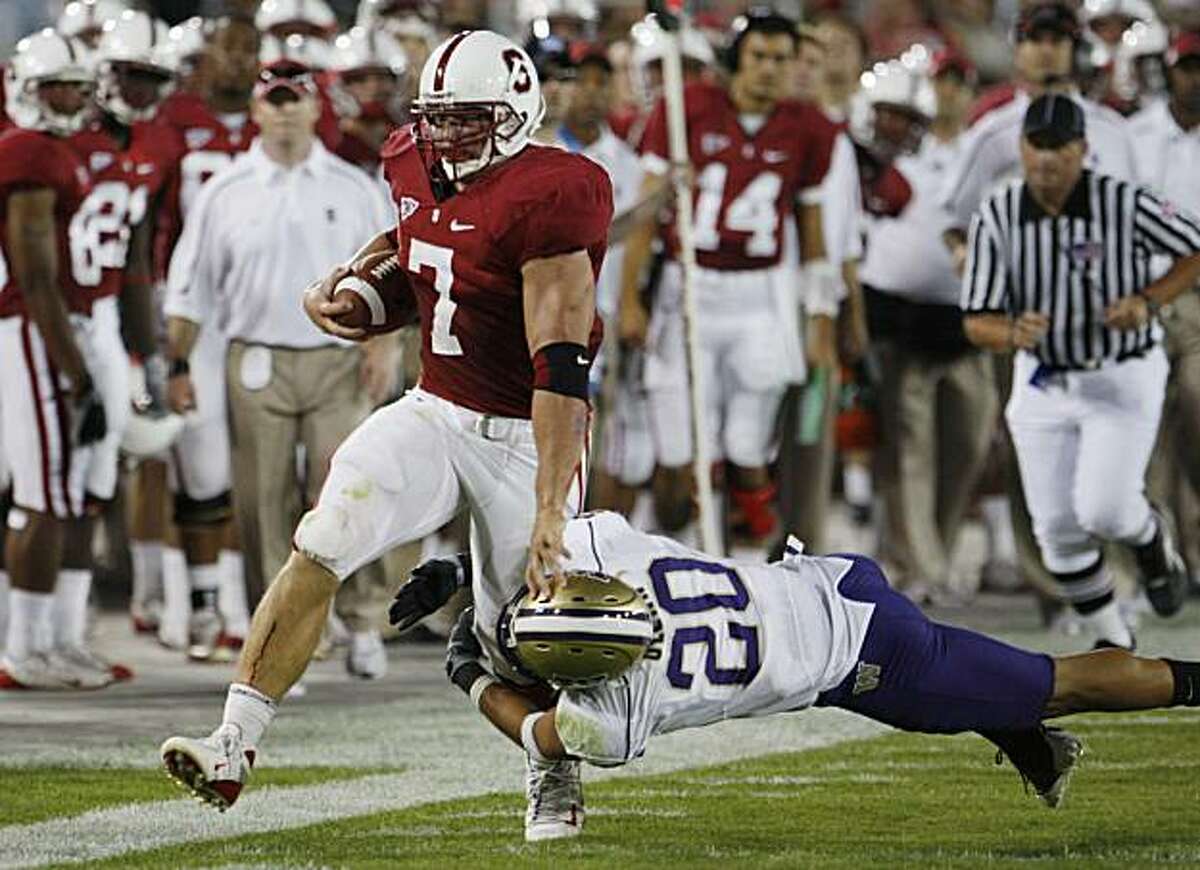 Stanford's Toby Gerhart tries break free from Washington's Cole Sager (20) in the second quarter of an NCAA football game in Stanford, Calif., Saturday, Sept. 26, 2009.