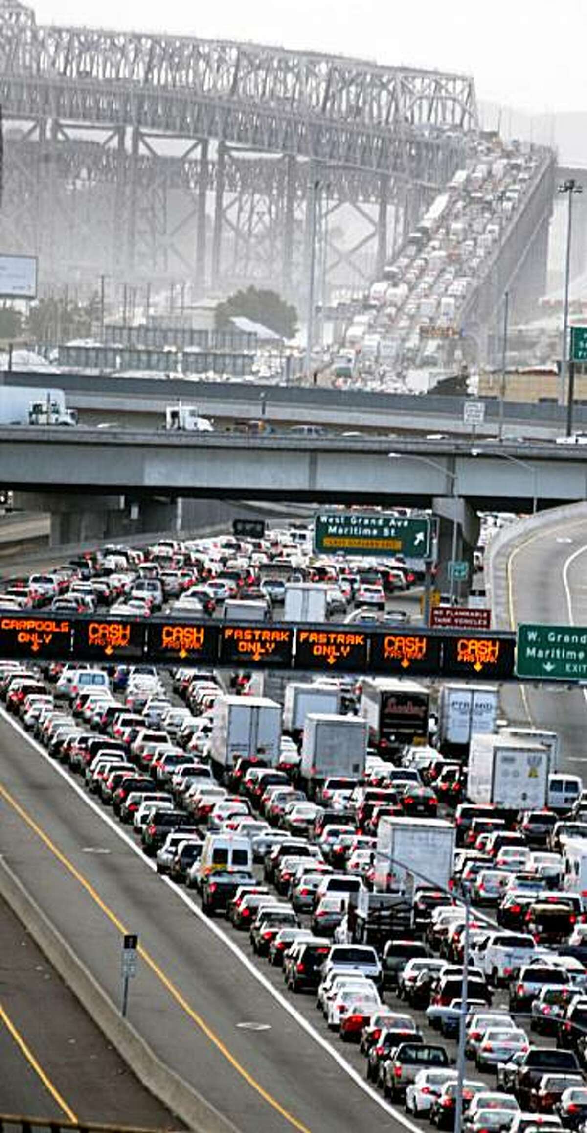 Hundreds of west bound commuters sit a wait on I-80 at the Bay Bridge approach to the toll booths after a big rig overturned on the westbound Bay Bridge just east of Yerba Buena Island Wednesday Oct 14, 2009. The accident blocked four of five lanes into San Francisco. The Safeway truck filled with food was reported on its side on the new S curve of the upper deck at 2:33 p.m. CHP reports that Debris spilled from the truck as it crashed compounding the clean up.