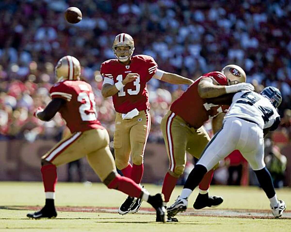 Quarterback Shaun Hill (13), center throws a pass to running back Frank Gore (21) in the fourth quarter against the Seattle Seahawks at Candlestick Park in San Francisco, Calif. on Sunday, Sept. 20, 2009. The 49ers defeated the Seahawks 23-10.
