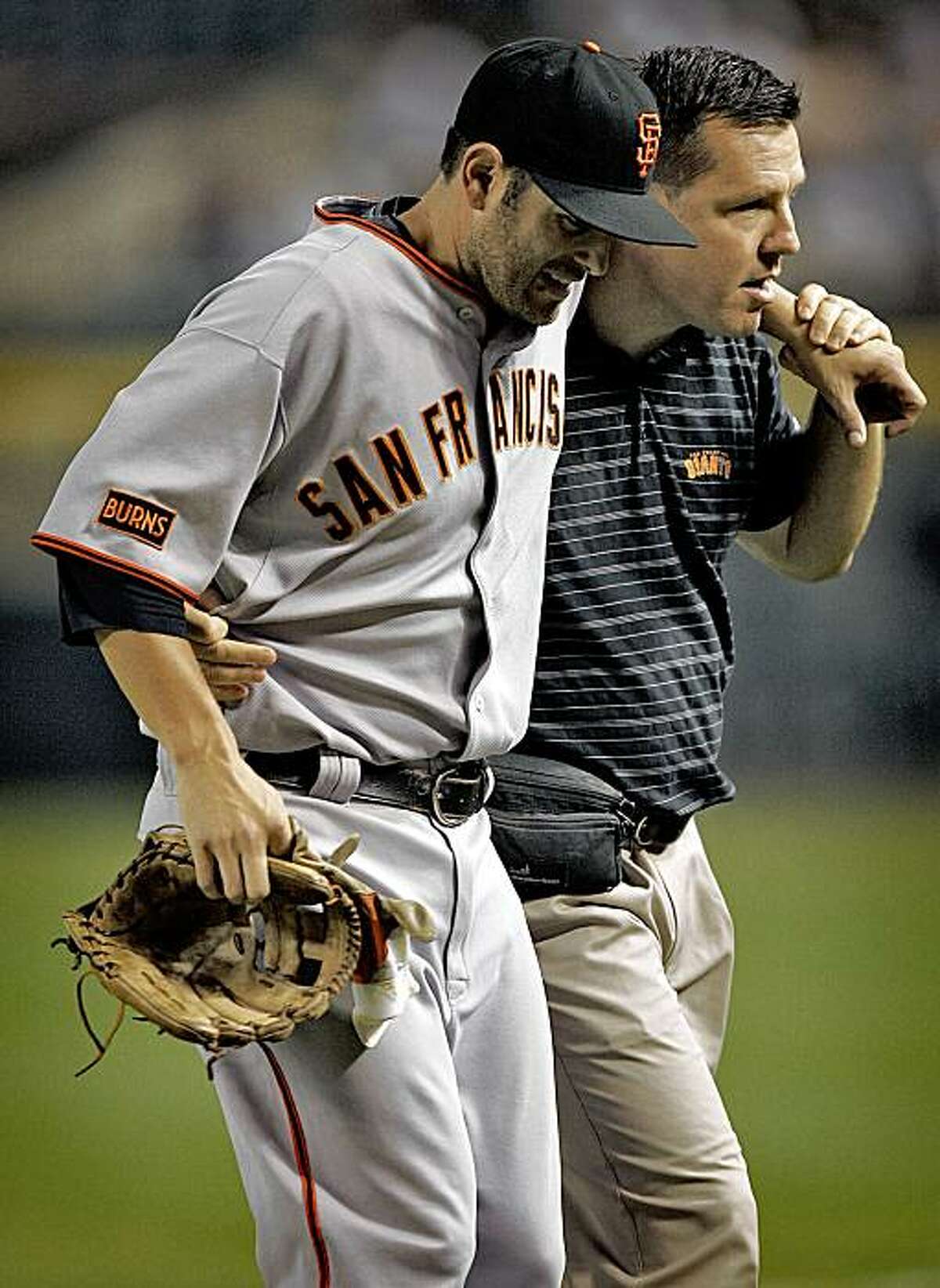 San Francisco Giants' Freddie Sanchez is helped off the field during the first inning of a baseball game against the Arizona Diamondbacks, Monday, Sept. 21, 2009, in Phoenix.