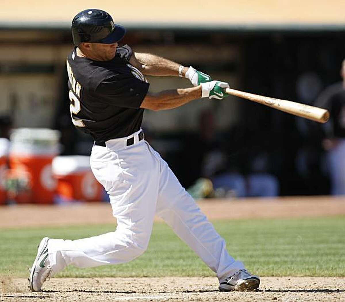 Oakland Athletics' Scott Hairston swings for a grand slam off Seattle Mariners' Shawn Kelley in the seventh inning of a baseball game Sunday, Sept. 6, 2009, in Oakland, Calif. (AP Photo/Ben Margot)