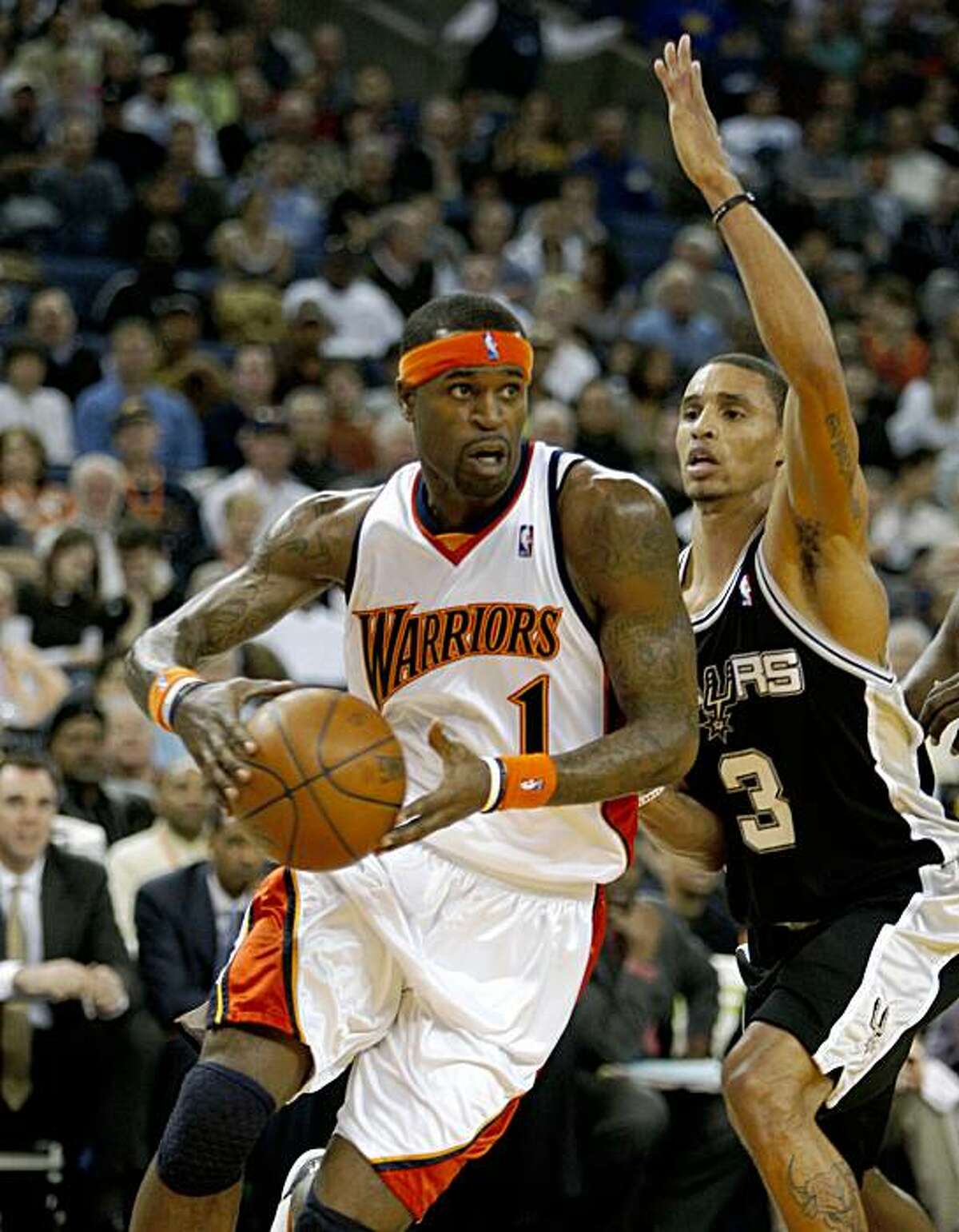 Golden State Warriors Stephen Jackson (1) drives to the basket against San Antonio Spurs George Hill (3) during a NBA game at Oracle Arena in Oakland, Calif., on Monday, February 2, 2009.