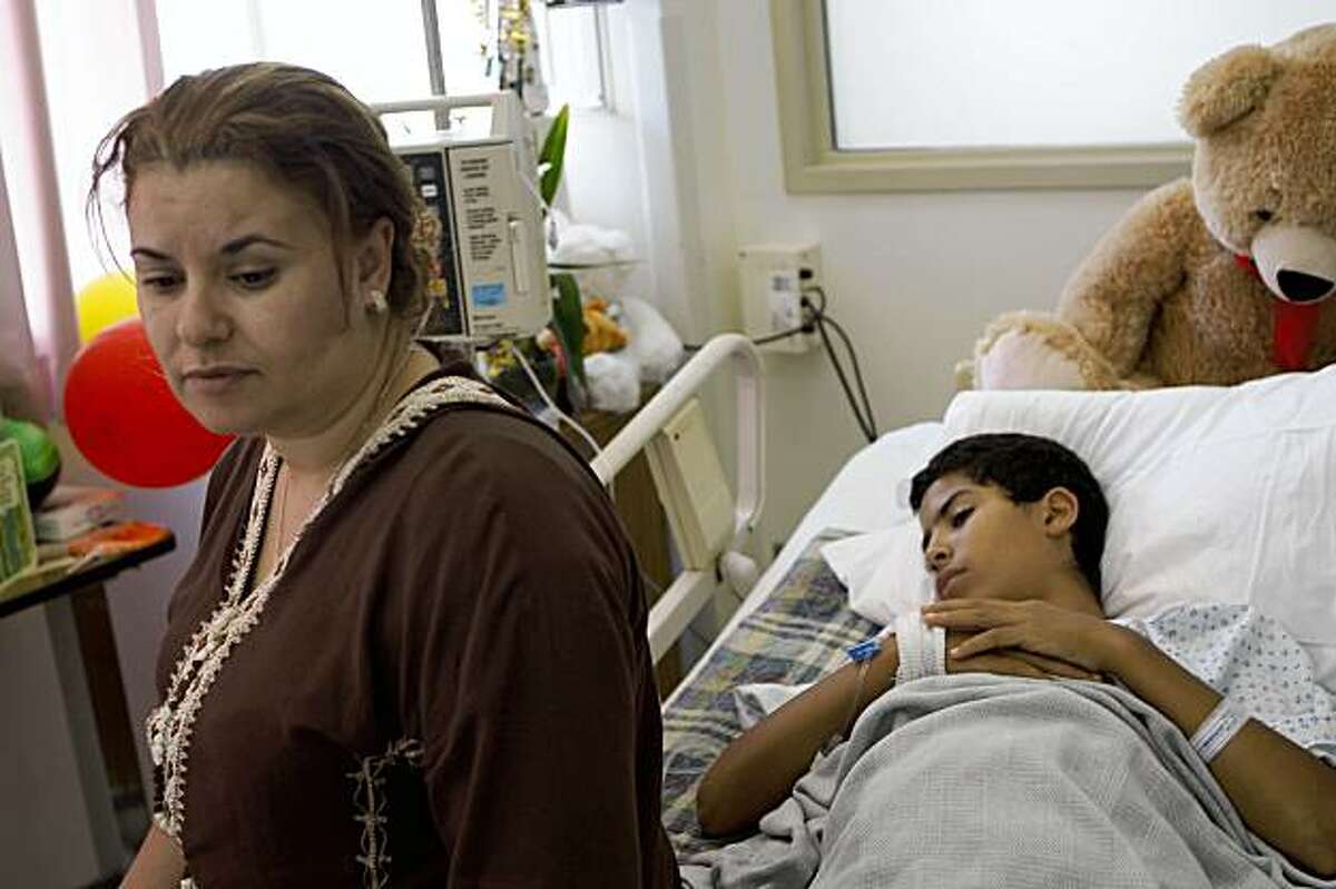 Laila Elfazouzi (left) sits with her son Hatim Mansori (right), 11 years old, at General Hospital in San Francisco, Calif. on Tuesday, September 8, 2009 where he is recovering after he was stabbed while riding home on the bus alone for the first time.