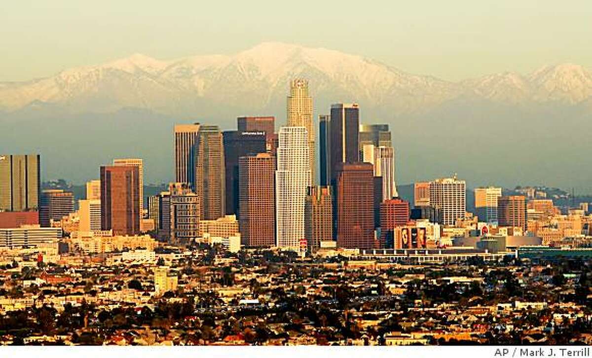 The downtown Los Angeles skyline with snow capped San Gabriel mountain range is seen here from a helicopter over the Baldwin Hills area of Los Angeles in this Jan. 12, 2005, file photo. The United States Olympic Committee will vote on April 14, 2007, choosing either Los Angeles or Chicago as the nation's candidate to host the 2016 Games. (AP Photo/Mark J. Terrill) Ran on: 04-29-2007