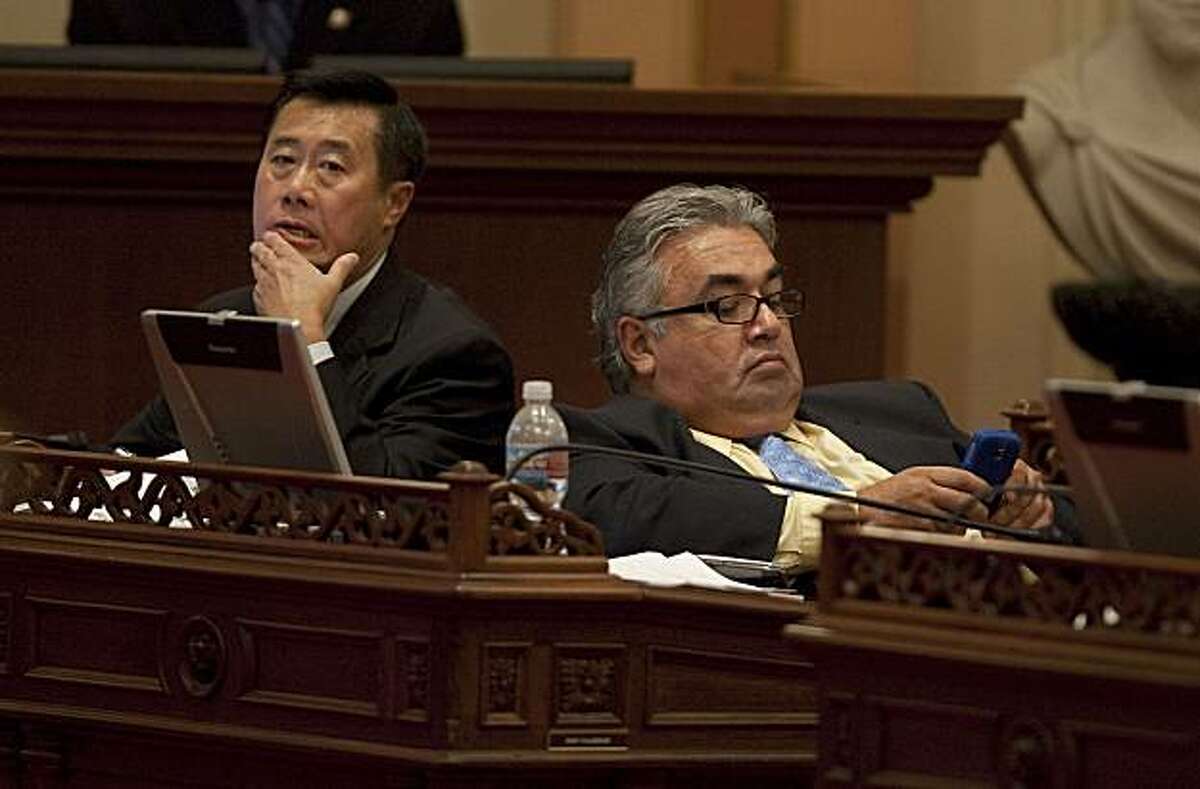 State Senators Leland Yee (D- San Francisco), left and Ronald Calderon (D-Montebello) right, listen to the debate on the budget bills in Sacramento, July 23, 2009.