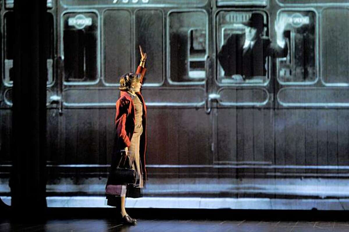Laura (Hannah Yelland, left) waves farewell to Alec (Milo Twomey) on the train in Kneehigh Theatre's adaptation of Noel Coward's "Brief Encounter" at ACT