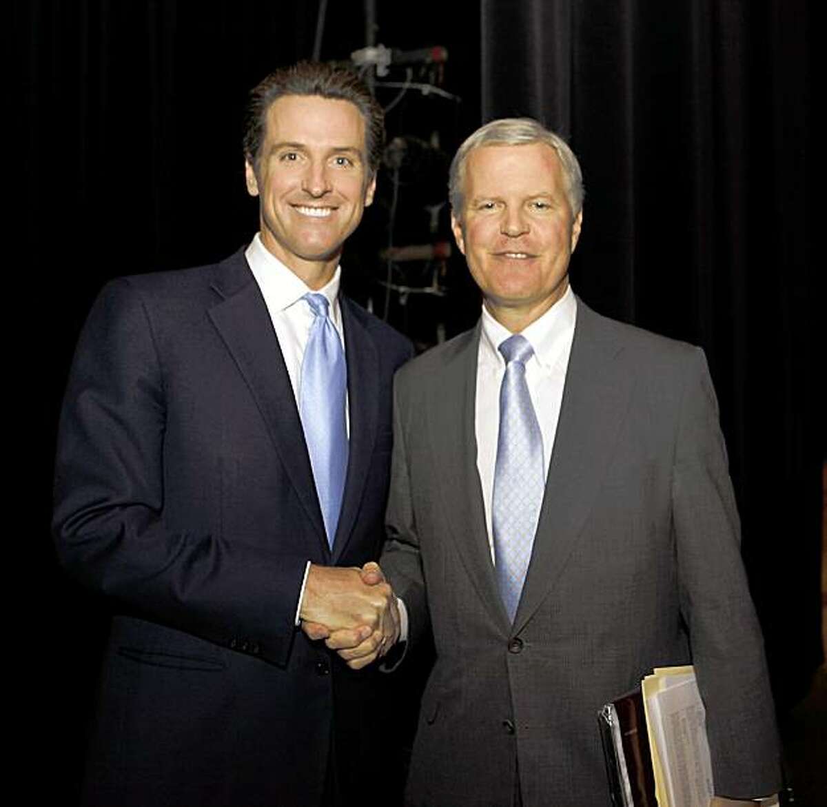California Finance Director Tom Campbell, right, who is running for Governor, shake hands with San Francisco Mayor Gavin Newsom, left, who is also running for Governor, backstage between panel discussions at Santa Clara University in Santa Clara, Calif., Wednesday, Sept. 16, 2009. (AP Photo/Paul Sakuma)