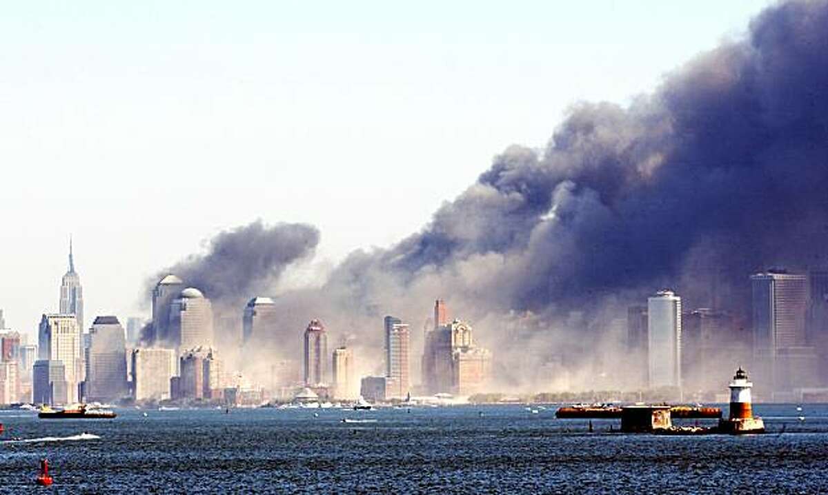 Smoke billows from lower Manhattan, Tuesday, Sept. 11, 2001, in New York, after two planes crashed into the World Trade Center, collapsing the twin 110-story towers. Explosions also rocked the Pentagon and the State Department. (AP Photo/Chad Rachman)