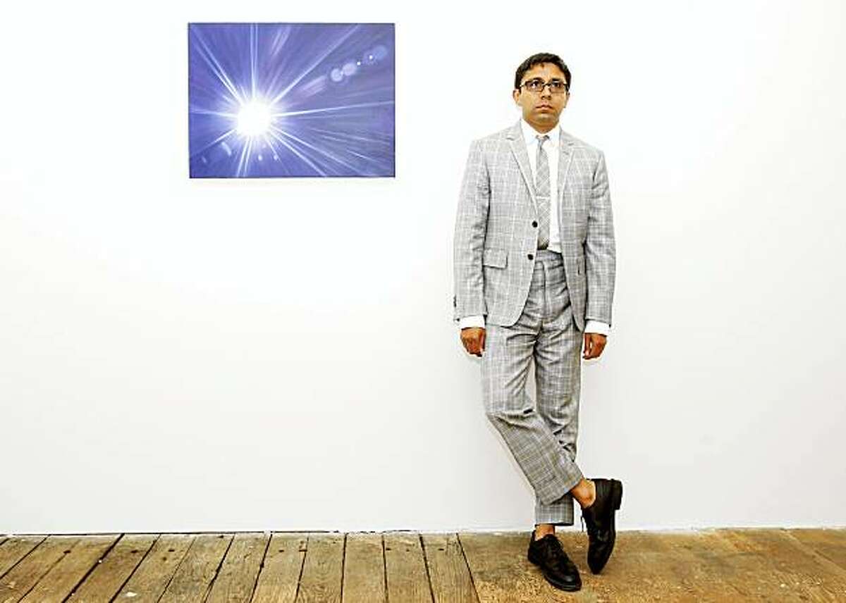 Chris Perez stands next to a painting by Jordan Kantor called Untitled (Basel lens flare 4496) in his gallery. Chris Perez runs the Ratio 3 gallery just off Valencia Street on Stevenson Street in San Francisco, CA.