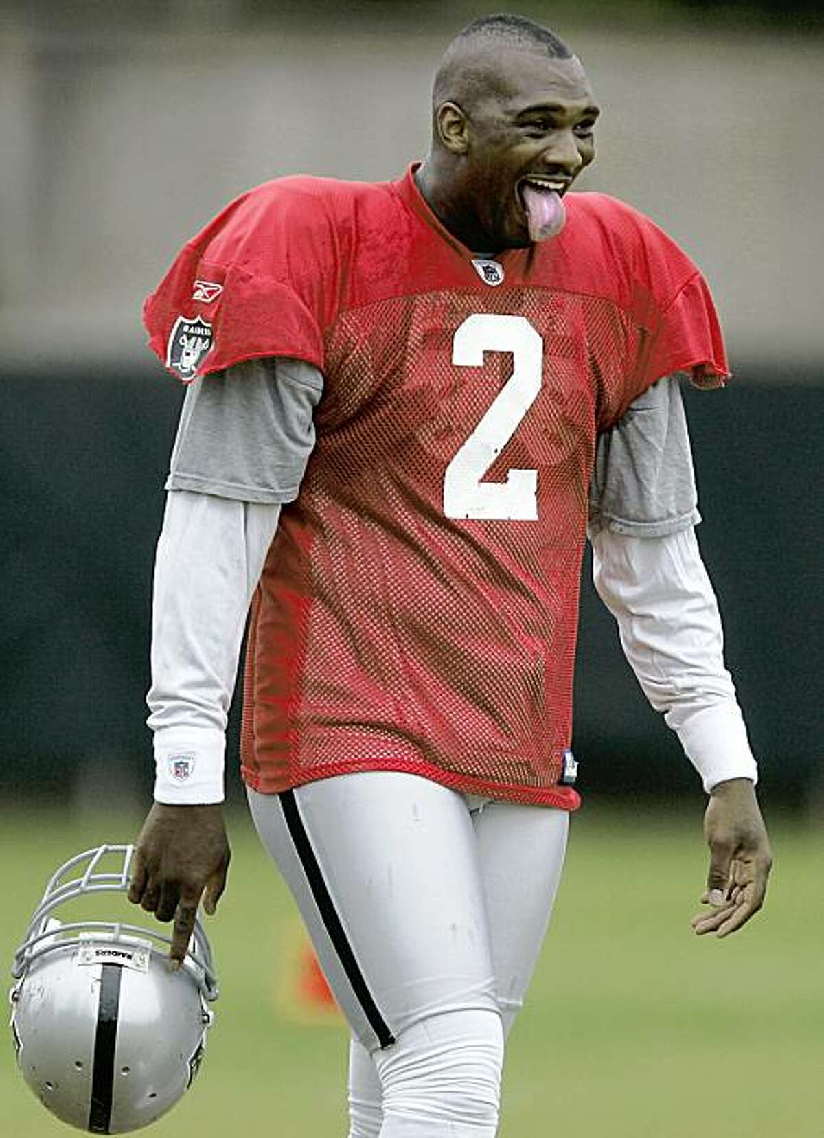 Oakland Raiders quarterback JaMarcus Russell makes a face at a teammate during training camp Wednesday, Aug. 19, 2009, in Napa, Calif. (AP Photo/The Press Democrat, Christopher Chung)