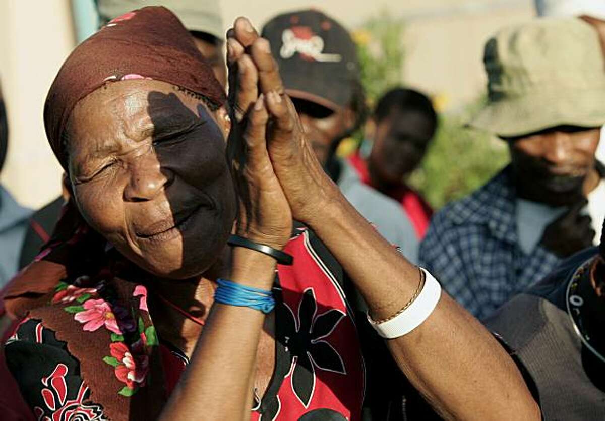 A member of the Kalahari Bushmen community celebrates a court ruling on their eviction from ancestral grounds.