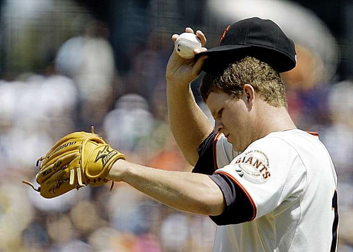 San Francisco Giants' Matt Cain adjusts his cap after giving up a home run to Cincinnati Reds' Brandan Phillips during the first inning of a baseball game Sunday, Aug. 9, 2009, in San Francisco. (AP Photo/Ben Margot)