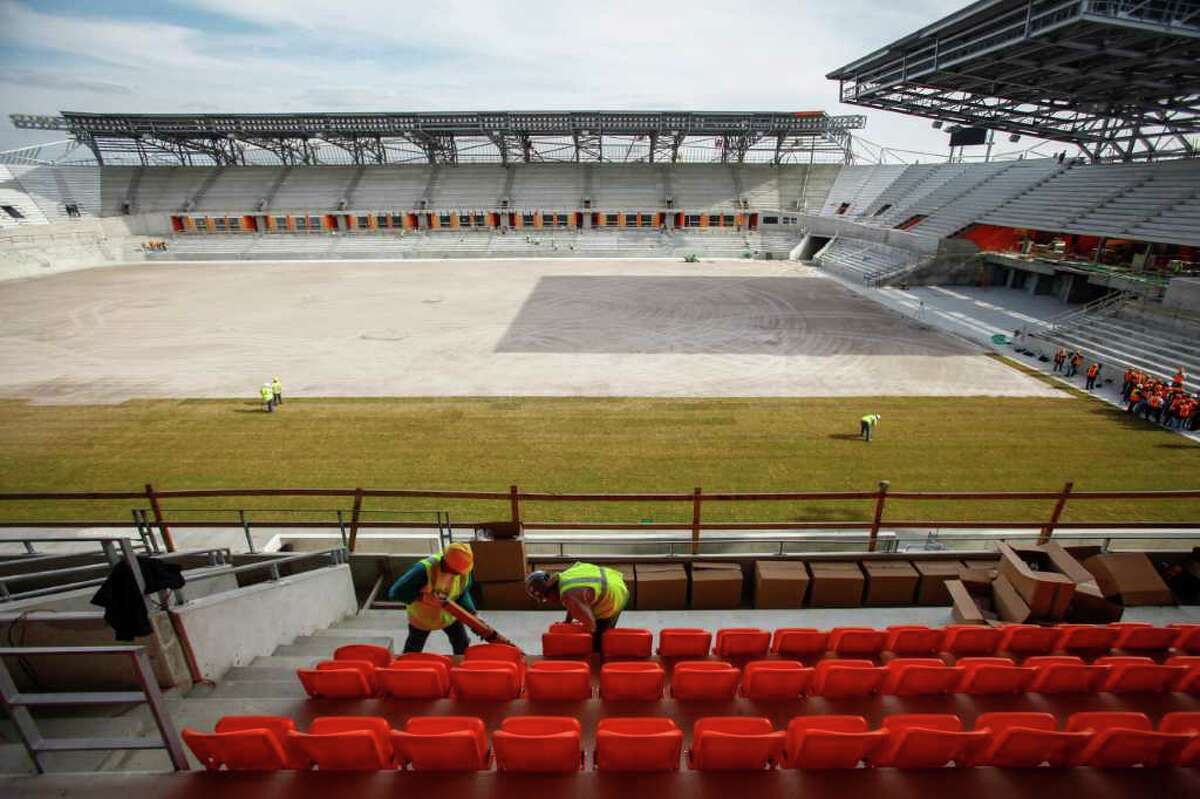 Joseph Louise (left) and Jose Moore install seats as seat installation and sod laying continues at the BBVA Compass Stadium where the Houston Dynamo soccer team will soon be playing, Wednesday, Feb. 8, 2012, in Houston. The state-of-the-art, open-air stadium is designed to host Dynamo matches as well as additional sporting and concert events. When it opens in 2012, the 22,000-seat stadium will be the first soccer-specific stadium in Major League Soccer located in a city's downtown district.