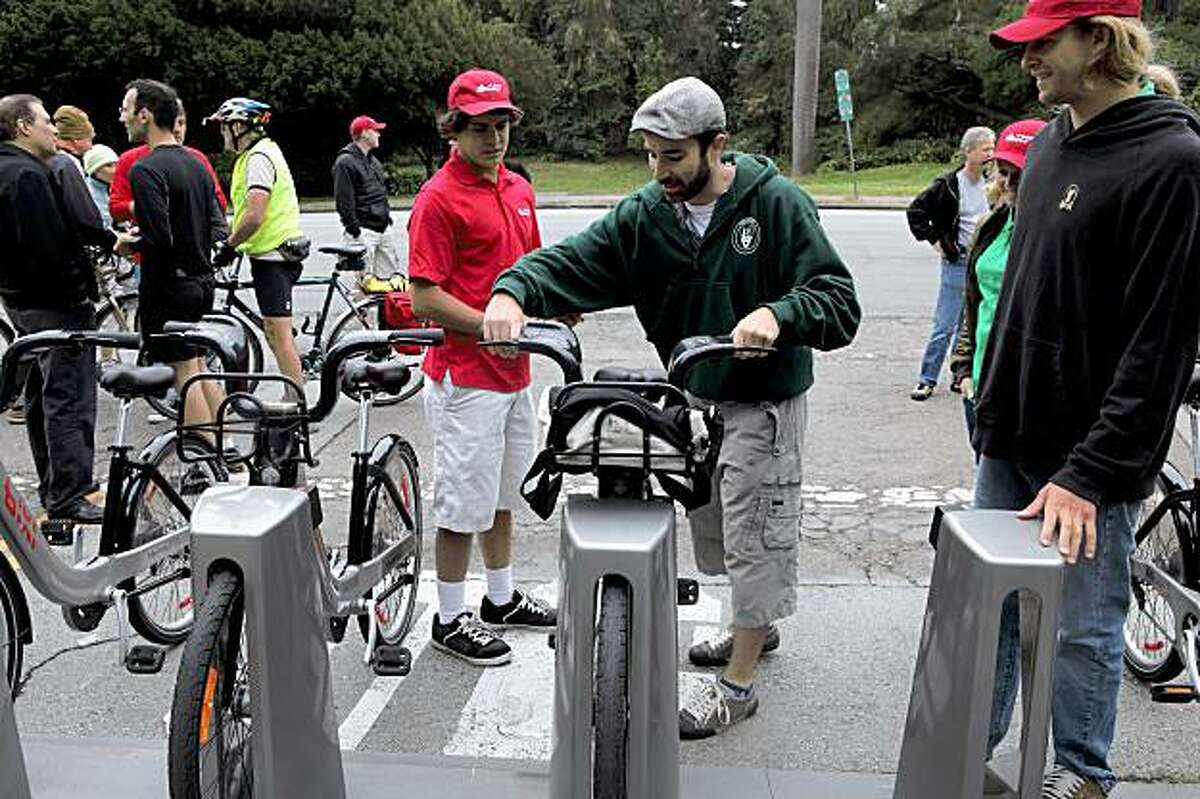Dale Danley, of San Francisco, checks out a bike from Bixi, Montreal's bike sharing system, in Golden Gate Park in San Francisco, Calif, on Sunday, August 2, 2009. The program offers bike sharing for customers -- short-term bicycle rentals located throughout the city. Proponents say the results include reduced traffic congestion and vehicle emissions, and also less demand for parking.