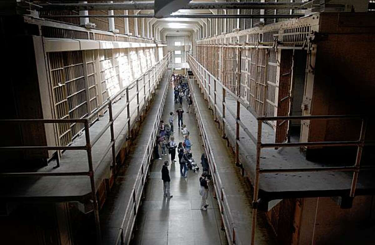 Visitors tour the main cellblock on Alcatraz Island in San Francisco, Calif., on Thursday, Aug. 6, 2009. Alcatraz will celebrate the 75th anniversary of its history as a federal prison this weekend.