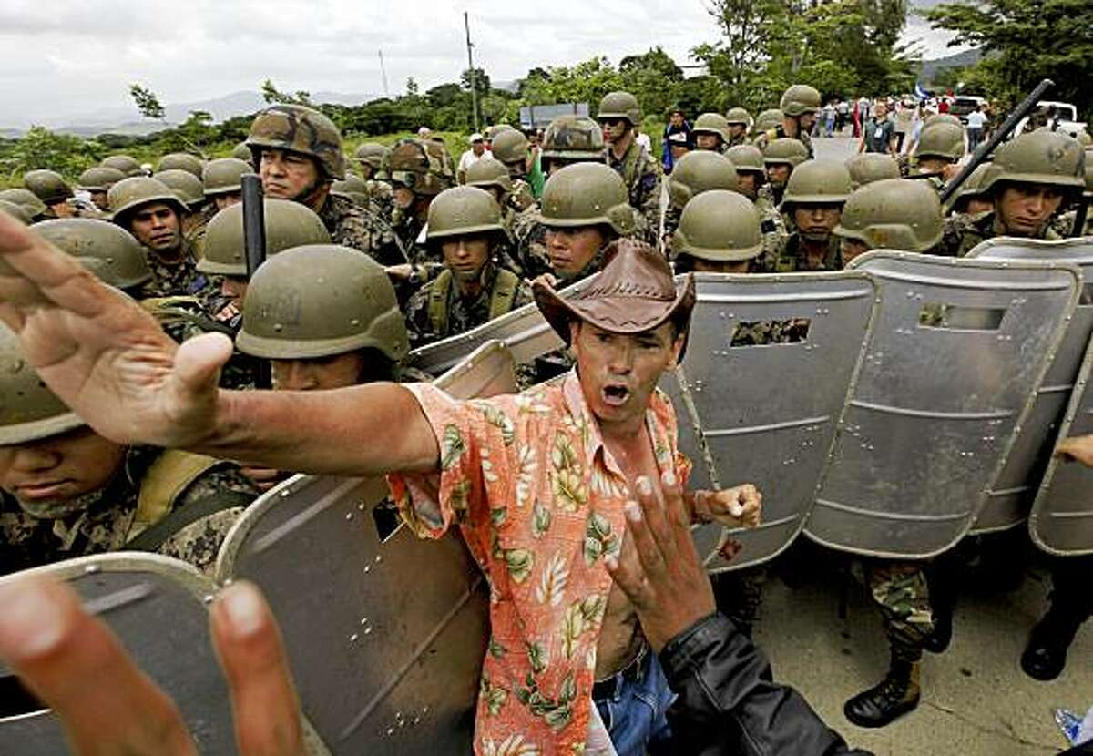 Supporters of Honduras' ousted President Manuel Zelaya clash with Honduran soldiers near the Nicaragua border in Paraiso, Honduras, Friday, July 24, 2009. Zelaya's supporters traveled to the remote border between Honduras and Nicaragua to support Zelaya's bid to reclaim the presidency from the government that ousted him in a June 28 coup. (AP Photo/Eduardo Verdugo)