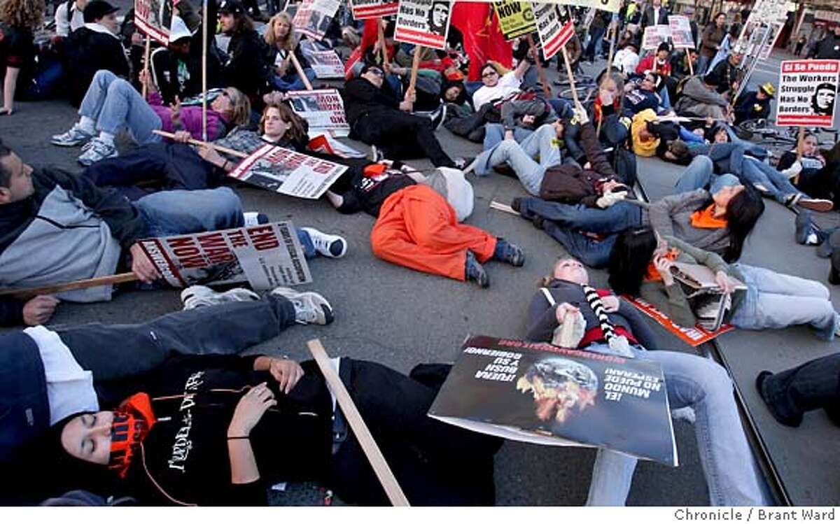 The protesters performed a "die in" every few blocks as they walked through the Mission district during the march. The five year anniversary of the Iraq war was remembered by protesters at San Francisco's Civic Center Wednesday, March 19, 2007. Photo by Brant Ward / San Francisco Chronicle