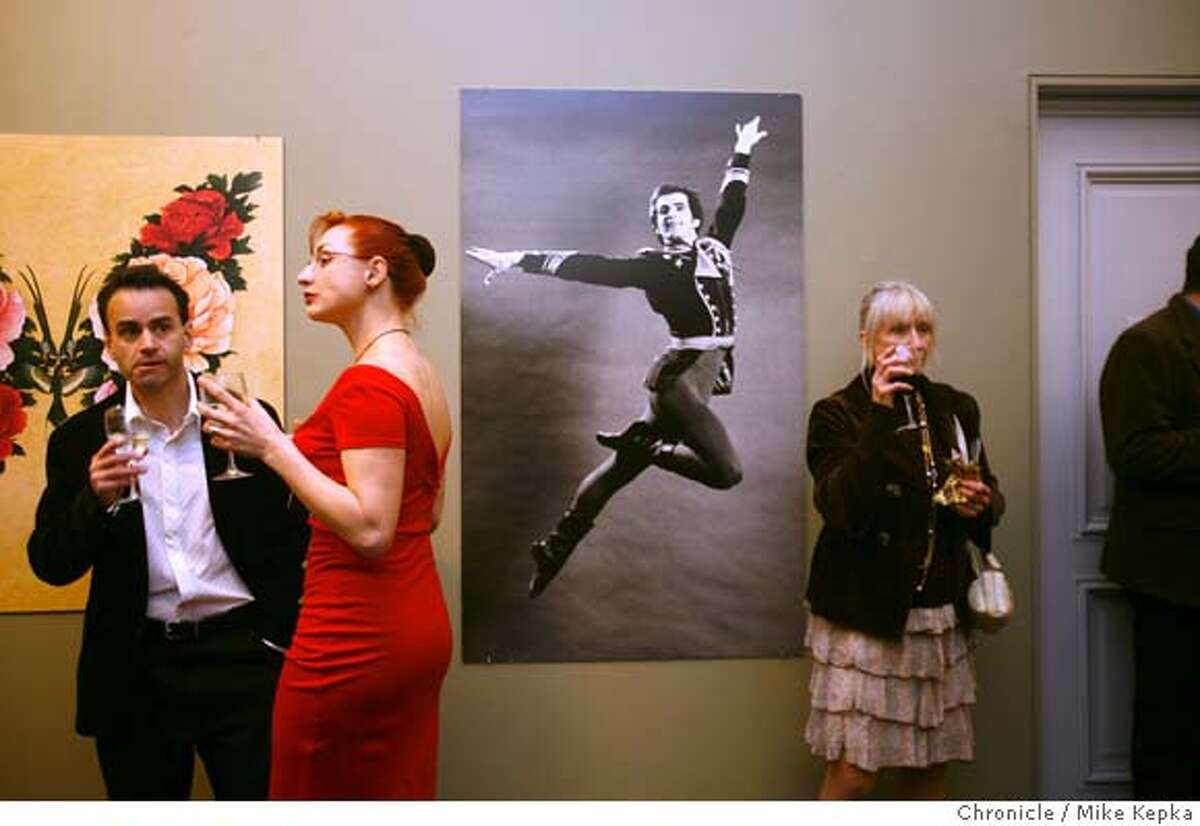 SF Ballet volunteers Jonathan Gohstand, and Anna Gohstand, with a photograph of Helgi Tomasson flying through the air during a 1970s performance of Stars and Stripes, share cocktails with SF Ballet alumna Betty Koerber Glover (rt) during a reception for a special exhibit now open at the Veteran's Building on Saturday, Mar. 15, 2008 in San Francisco, Calif. Photo by Mike Kepka / San Francisco Chronicle