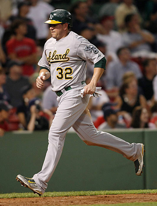 Boston Red Sox second baseman Dustin Pedroia lands on Oakland Athletics' Orlando  Cabrera, who is out at second, as he turns a double play to end the top of  the eighth inning