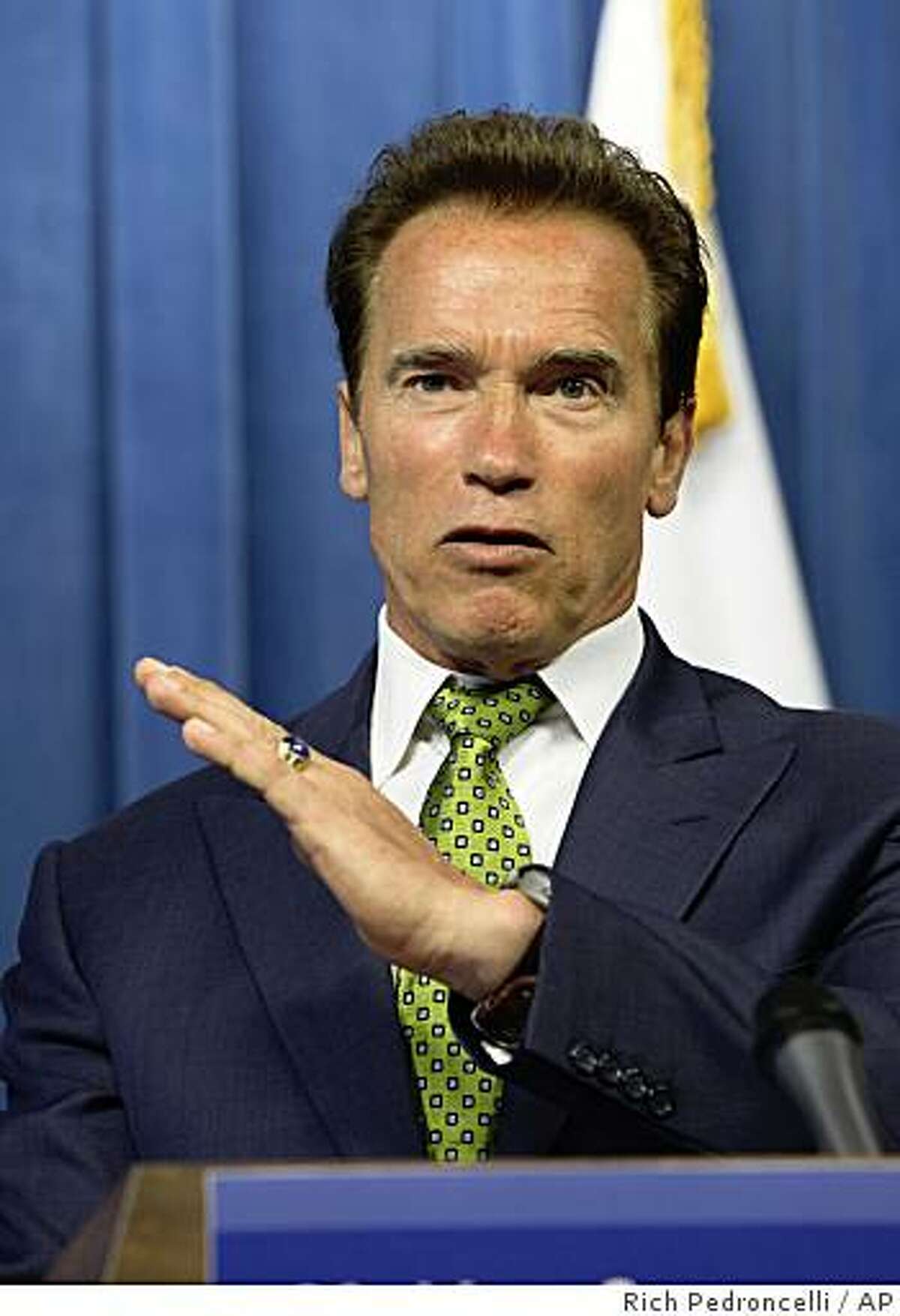 Gov. Arnold Schwarzenegger gestures as he defends his proposals to reform welfare and other social programs as negotiations over closing California's $26.3 billion deficit during a Capitol news conference in Sacramento, Calif., Wednesday, July 8, 2009.(AP Photo/Rich Pedroncelli)