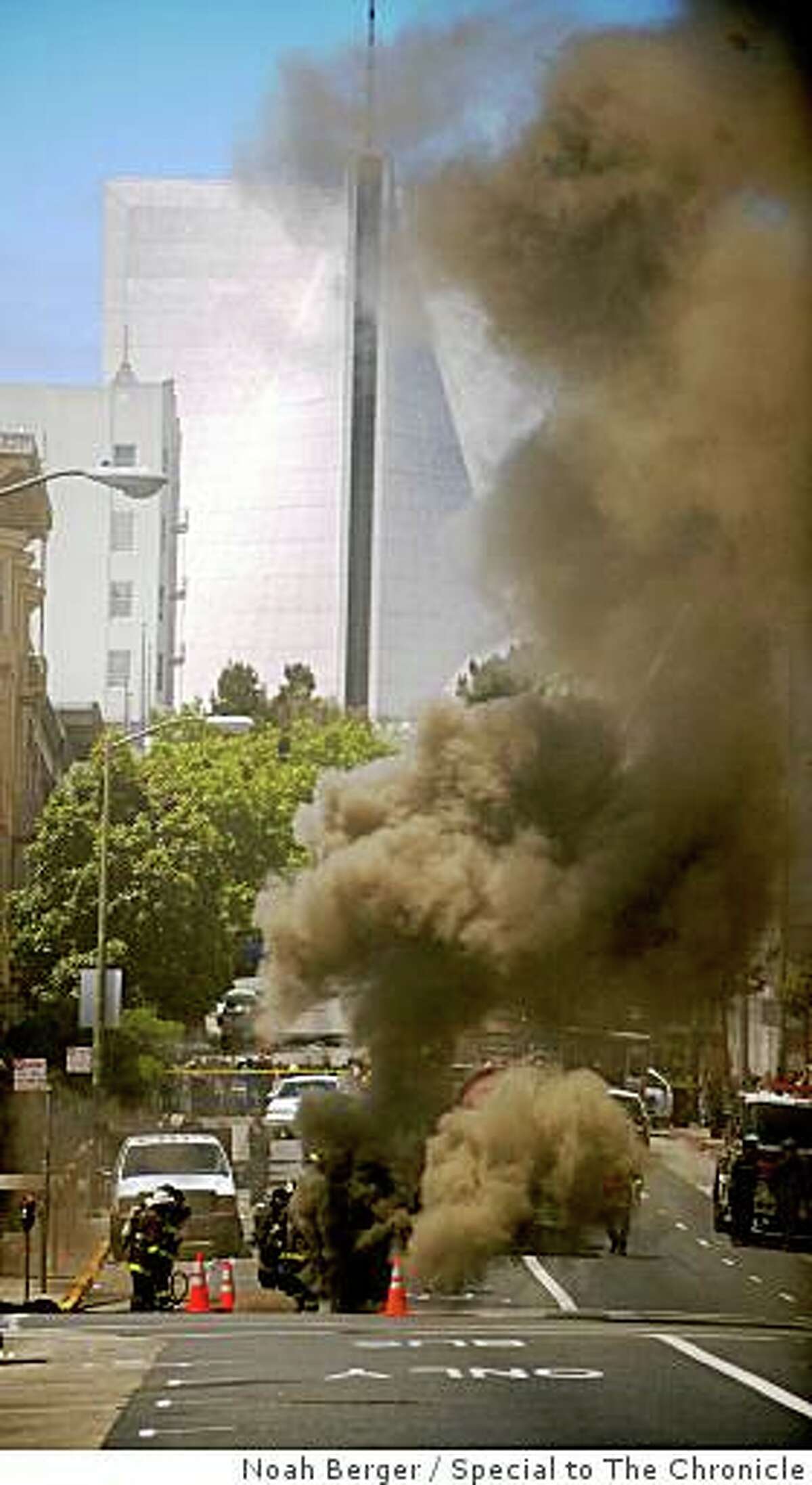 Firefighters fight an underground fire on O'Farrell Street in San Francisco on June 5, 2009. The underground explosion and fire in Tenderloin cut off power to 3,200 people, trapped some in elevators, and prompted a shelter-in-place order.