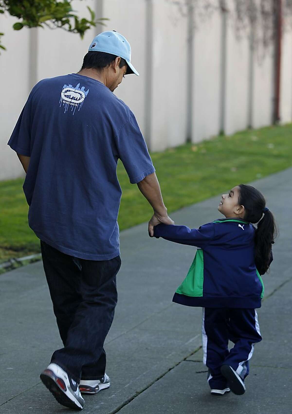 Jesus Navarro walks with his 3-year-old daughter Karin Jacquelin after discussing his need for a kidney transplant in Berkeley, Calif. on Thursday, Feb. 9, 2012. However, Navarro's immigration status may create complications in his receiving publicly-assisted post-op medical care.