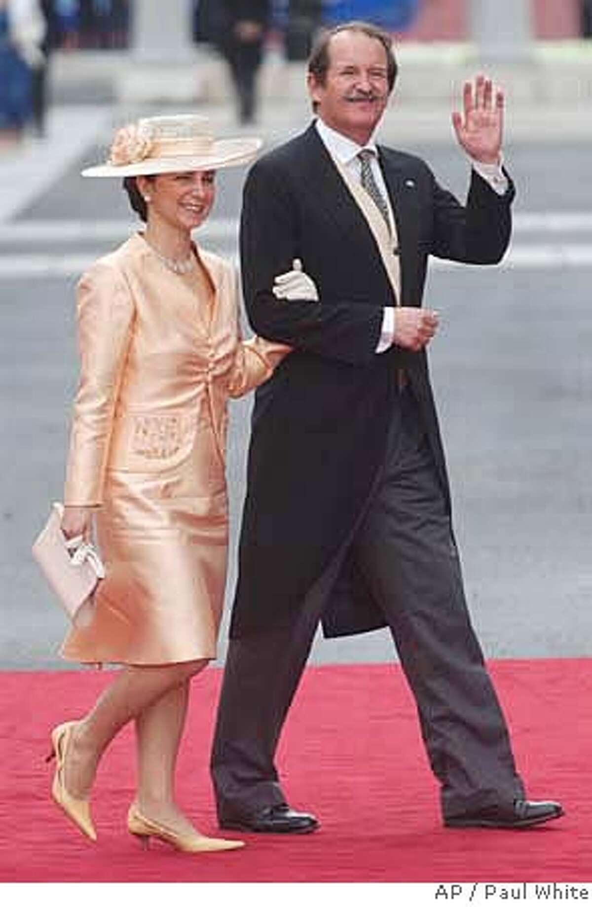 **APN ADVANCE FOR SUNDAY FEB. 17** Portugal's Duke of Braganza Duarte Pio, the next in line to the Portuguese throne, and his wife Isabel Herediaare seen arriving at Madrid's Almudena cathedral in this May 22 2004 file photo, to attend the wedding of Spain's Crown Prince Felipe to Letizia Ortiz. The centenary on Feb. 1 2008 of the assassination of Portuguese King Carlos I has taken Duarte Pio beyond the pages of glossy magazines and into the mainstream political debate. Pio would by birthright be sovereign if Portugal restored its monarchy, and he is using public interest in the Friday centenary of King Carlos I's assassination to make his case for a return to royal influence on a continent proud of its democratic traditions. He claims that at the start of the past century, before republicans deposed Carlos I's successor - Manuel II - by force in 1910, Portugal packed a bigger economic and diplomatic punch than it does now as one of the European Union's lightweights. (AP Photo/Paul White) **APN ADVANCE FOR SUNDAY FEB. 17**