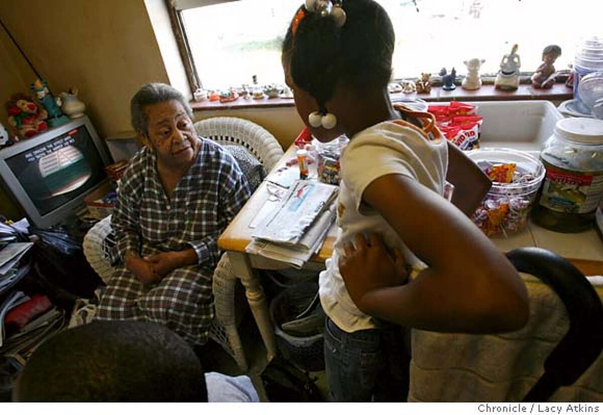 Eris White, 83, talks with a young girl as she buys some candy, March 29, 2007 at her home in the Sunnydale Projects in Visitation Valley of San Francisco, Ca. She is known as grandma that runs the candy house. Where people come to buy candy, soda's, and cigarettes. (Lacy Atkins / San Francisco Chronicle)