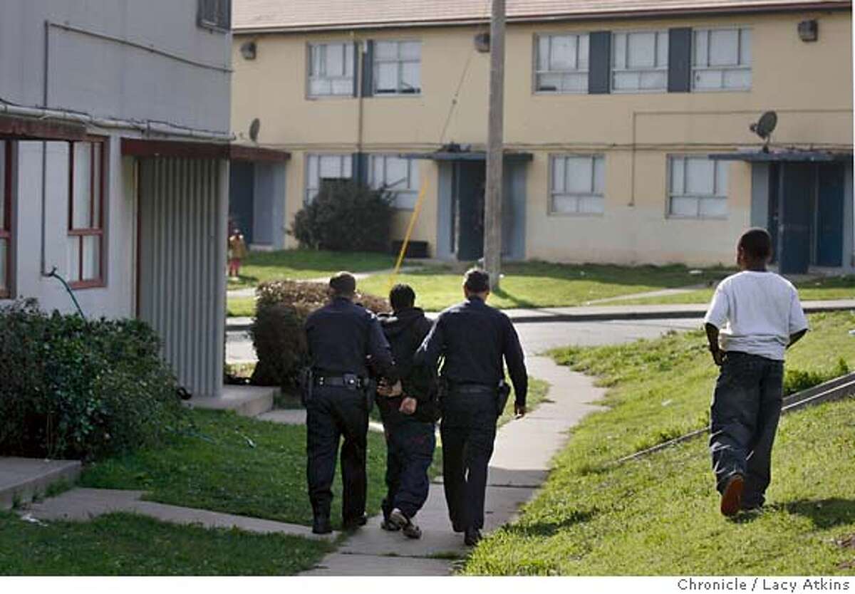 San Francisco Police Officers arrest a young man suspected of gang activity and weapon position, Monday Nov. 13, 2007, in the Sunnydale Project in San Francisco, Ca. Photographer: Lacy Atkins /San Francisco Chronicle Photo taken on 11/12/07, in san francisco, CA, USA