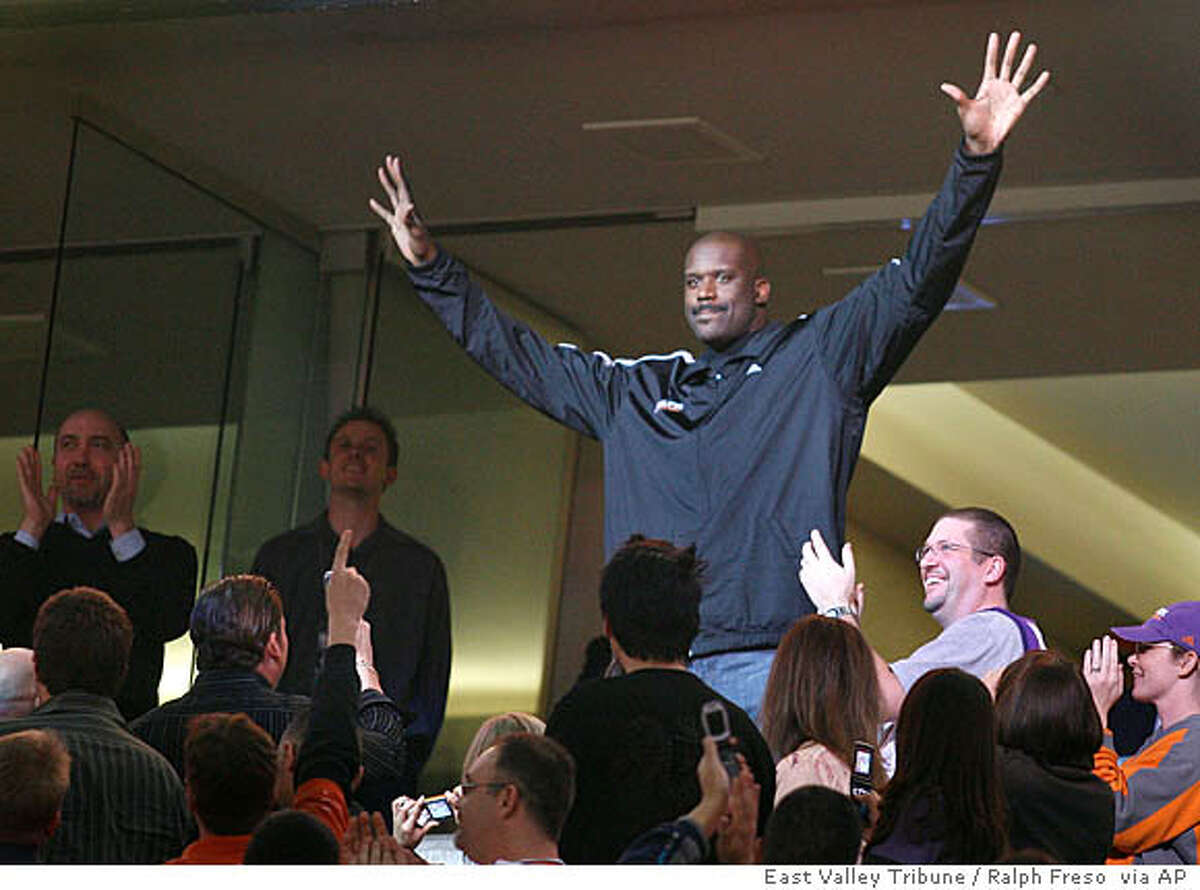 Phoenix Suns newly-acquired center Shaquille O'Neal acknowledges fans after being introduced as the Suns play against the New Orleans Hornets in an NBA basketball game, Wednesday, Feb, 6, 2008 in Phoenix. The Suns acquired O'Neal in a stunning, blockbuster deal that sent four-time All-Star Shawn Marion and Marcus Banks to the Miami Heat on Wednesday. (AP Photo/ East Valley Tribune / Ralph Freso