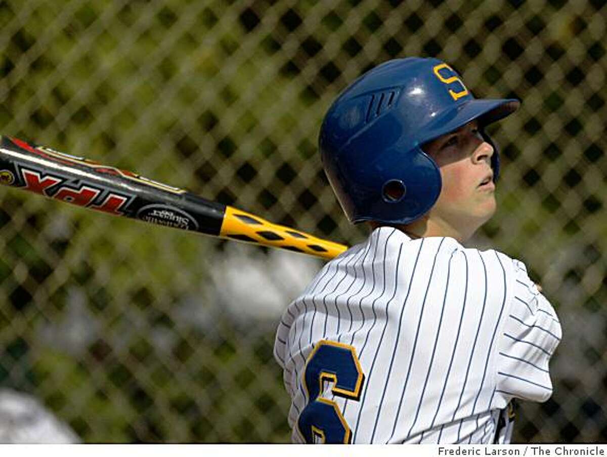 Teen ballplayer tips cap to BALCO trainer